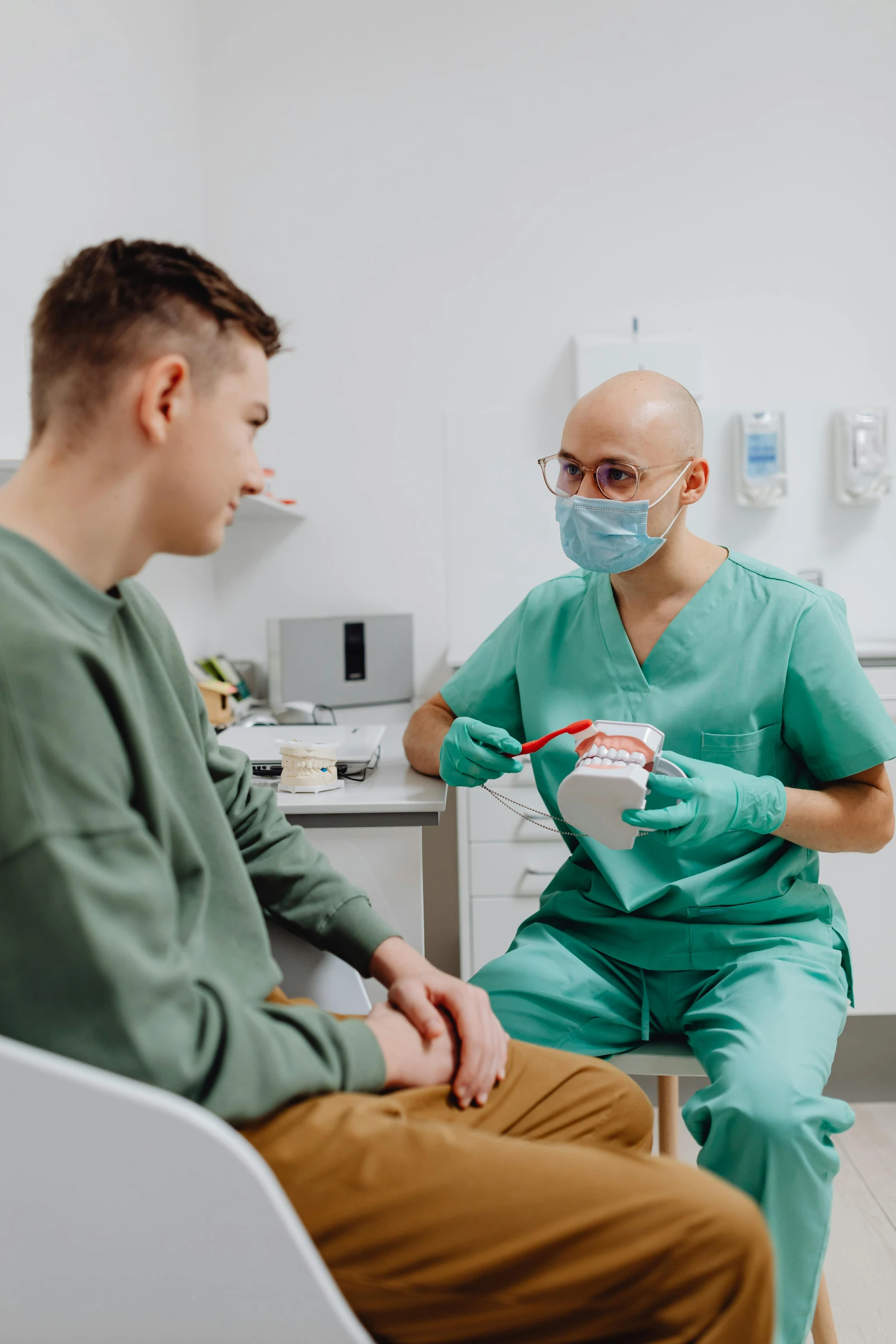 a man in a green scrub is holding a cup