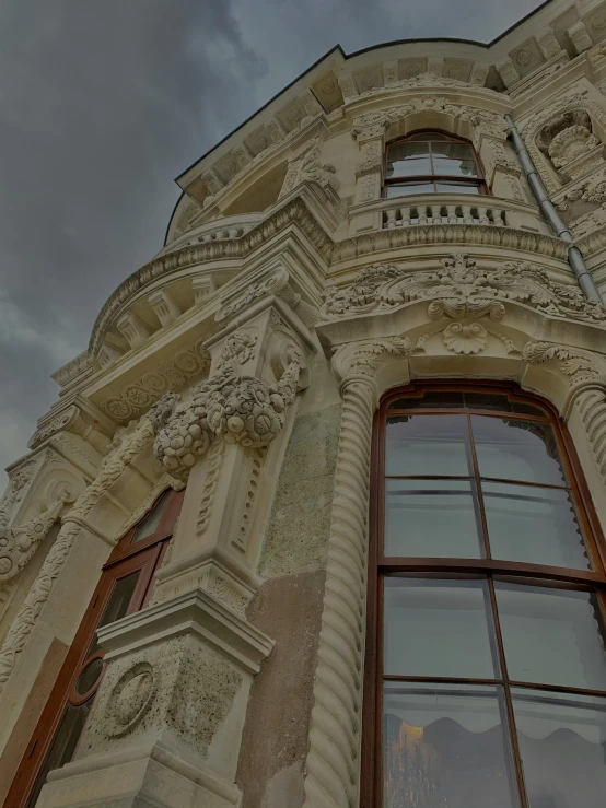 a building is shown against the sky and clouds