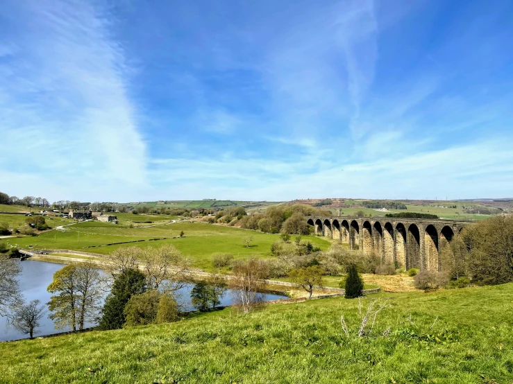 a large old bridge spanning a river into the sky