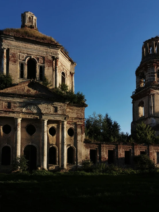 there are two stone buildings with trees and flowers on the top