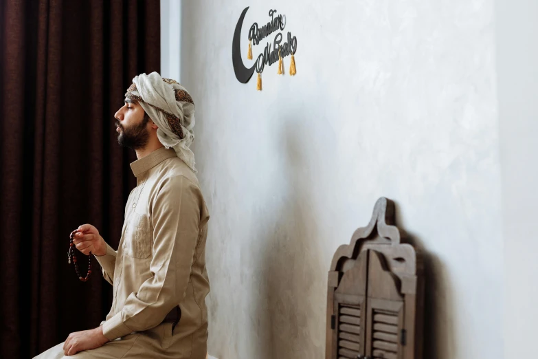 man standing by a wall with a clock and writing on the wall