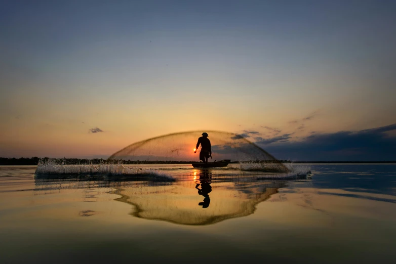 a person is standing on the side of the water