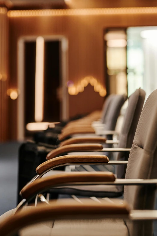 a row of leather office chairs sitting on top of a hard wood floor