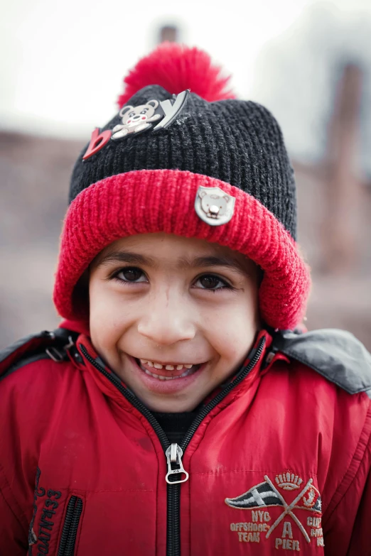 this is a boy with a sweater and hat on