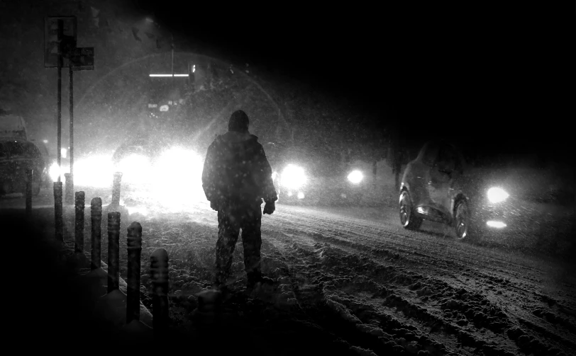 two men standing in the snow on a street