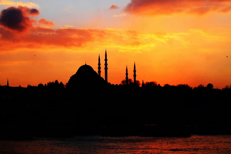 the setting sun lights up the silhouette of a building