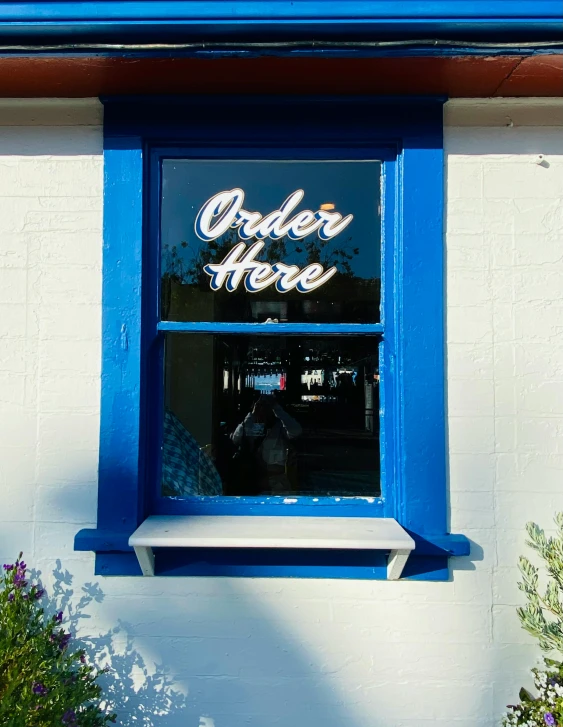 a white bench and some blue windows on the side of a building