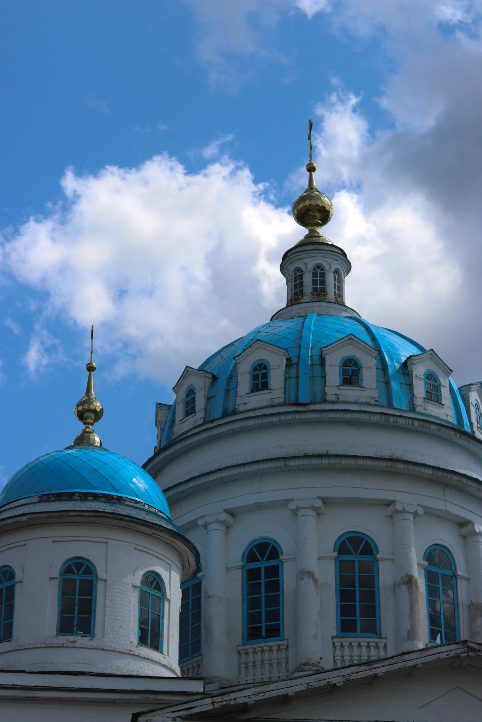 two white buildings with blue roof tops