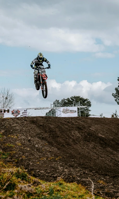 a motorcyclist making a high jump on his bike