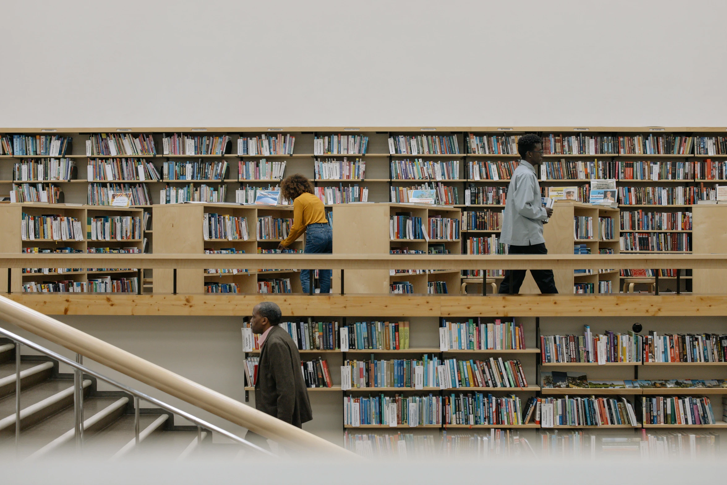 two people reading books inside of a liry