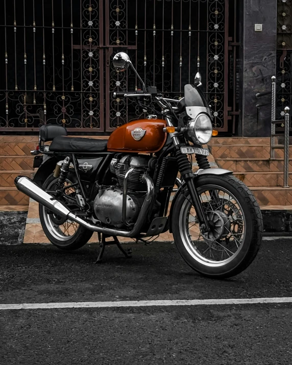 a classic motorcycle parked by the side of a building