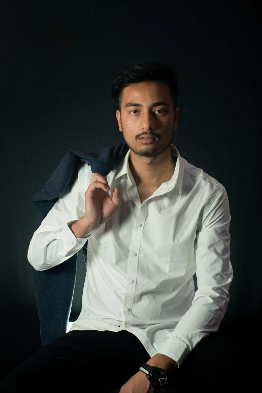 a man in white shirt and dark pants posing for the camera