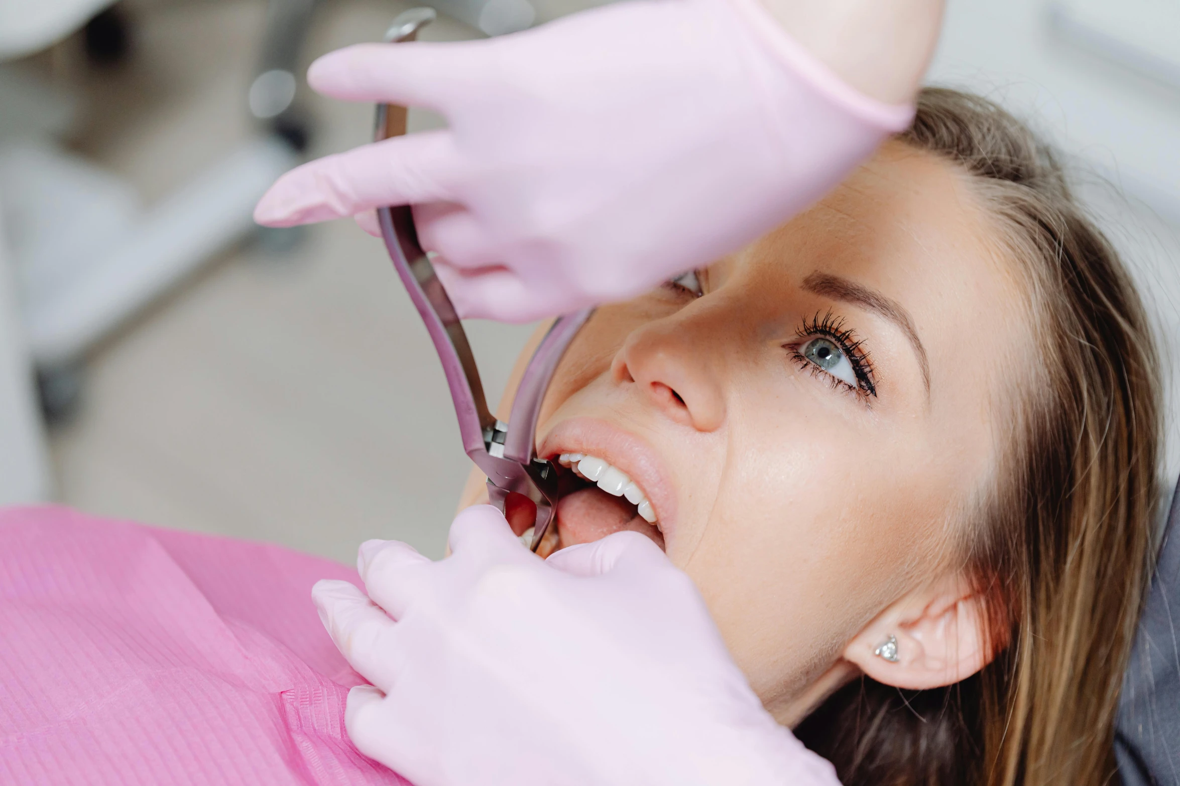 a woman that is holding some purple handles to her teeth