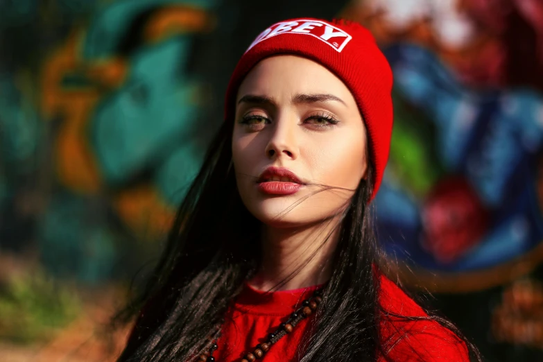 a close up of a woman wearing a red hat