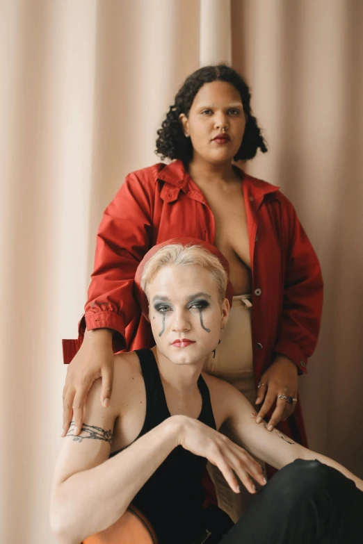 woman with face paint poses with one hand on the shoulder