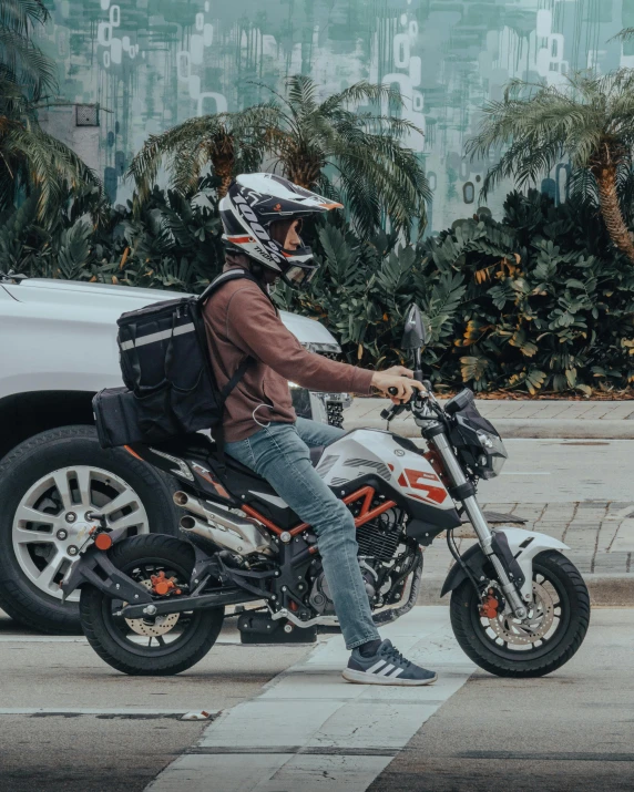 a man on a motorbike riding on the street