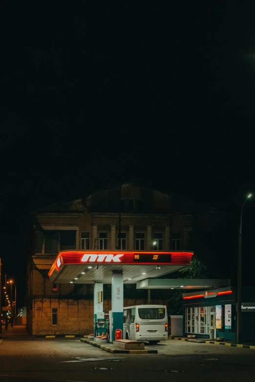 a very dark gas station with no people on the street