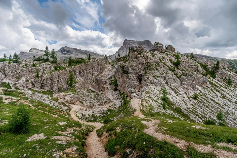 some large rocks are stacked together on a hill