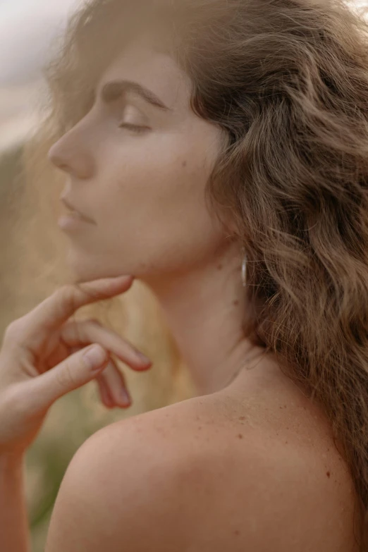 a woman with long hair looking off to the side