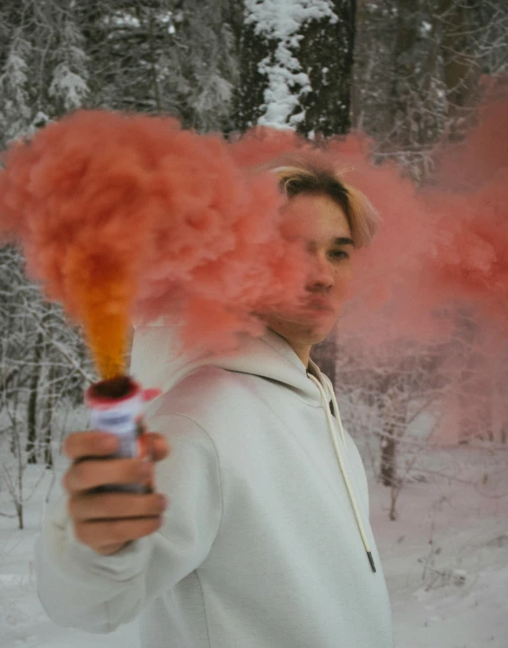 person with pink smoke cloud in hands