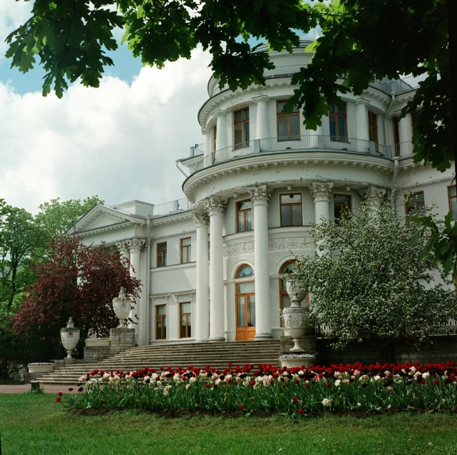 an old white building that has many arches and windows