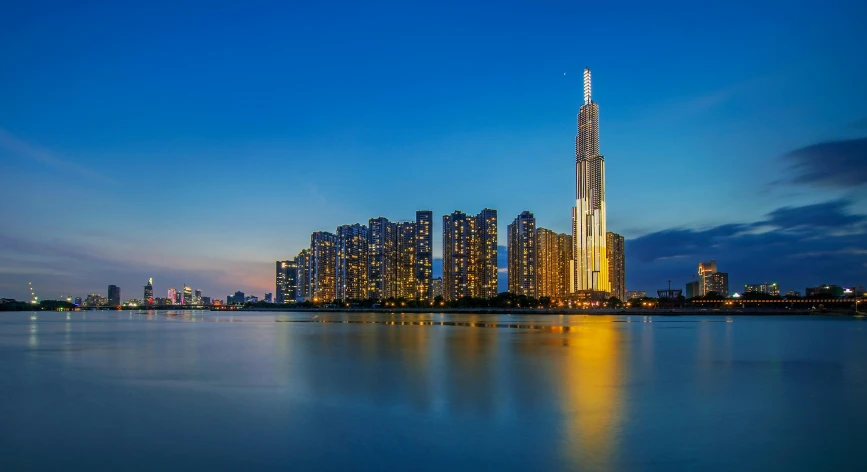 skyscrs in the middle of a city are reflected on water