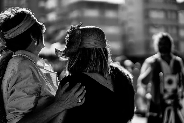 black and white po of two women sharing a moment on a street