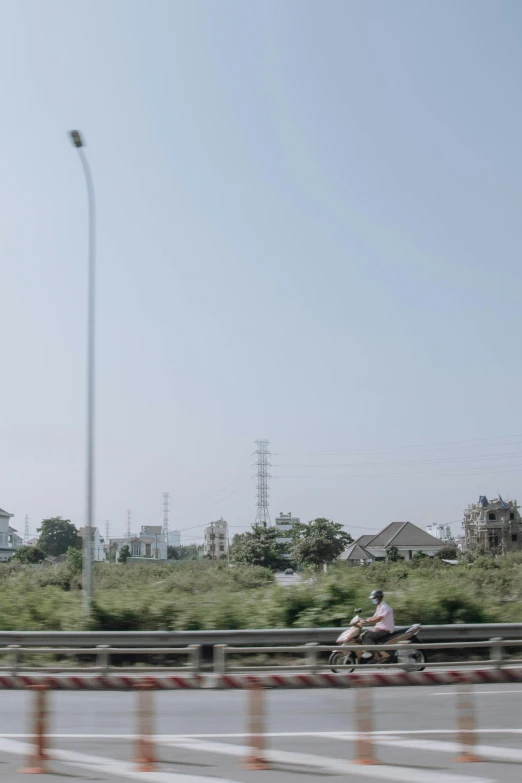 two men riding motorcycles down the middle of an empty street