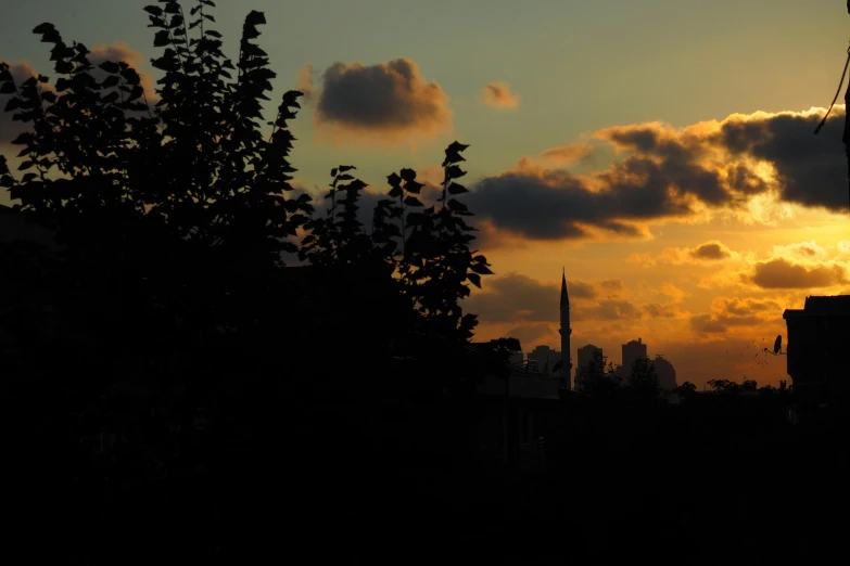 sunset seen from a hill near some buildings