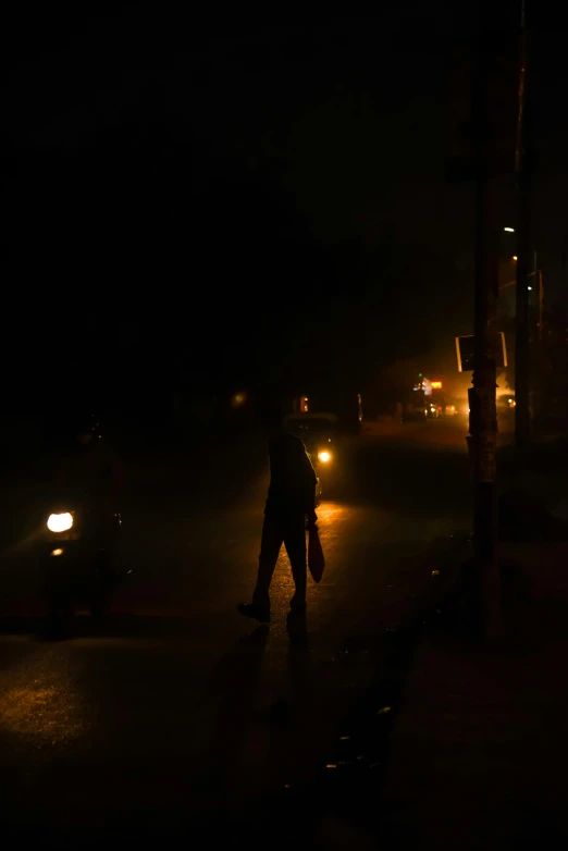 a man walking down a street at night