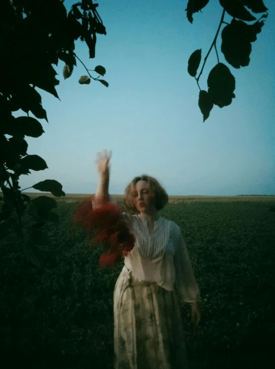 a person with a bouquet holding up a bird