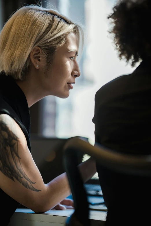 a woman has a tattoo on her arm and head