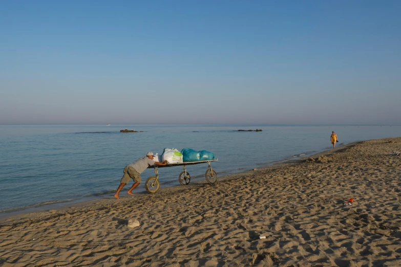 a man and child hing a boat out of the ocean