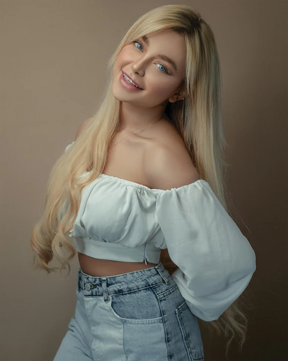 a woman posing in an off - the - shoulder top and denim skirt