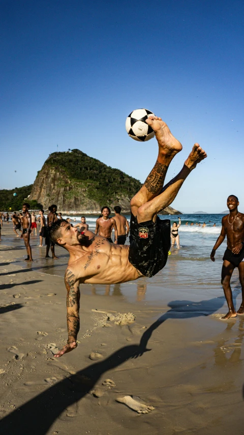 the man in black shorts is kicking a soccer ball