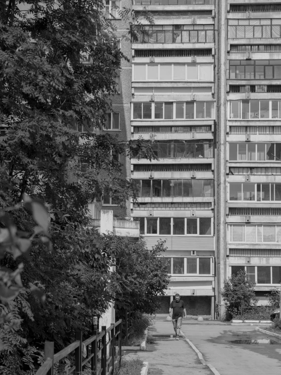 a person riding a skateboard past an old building