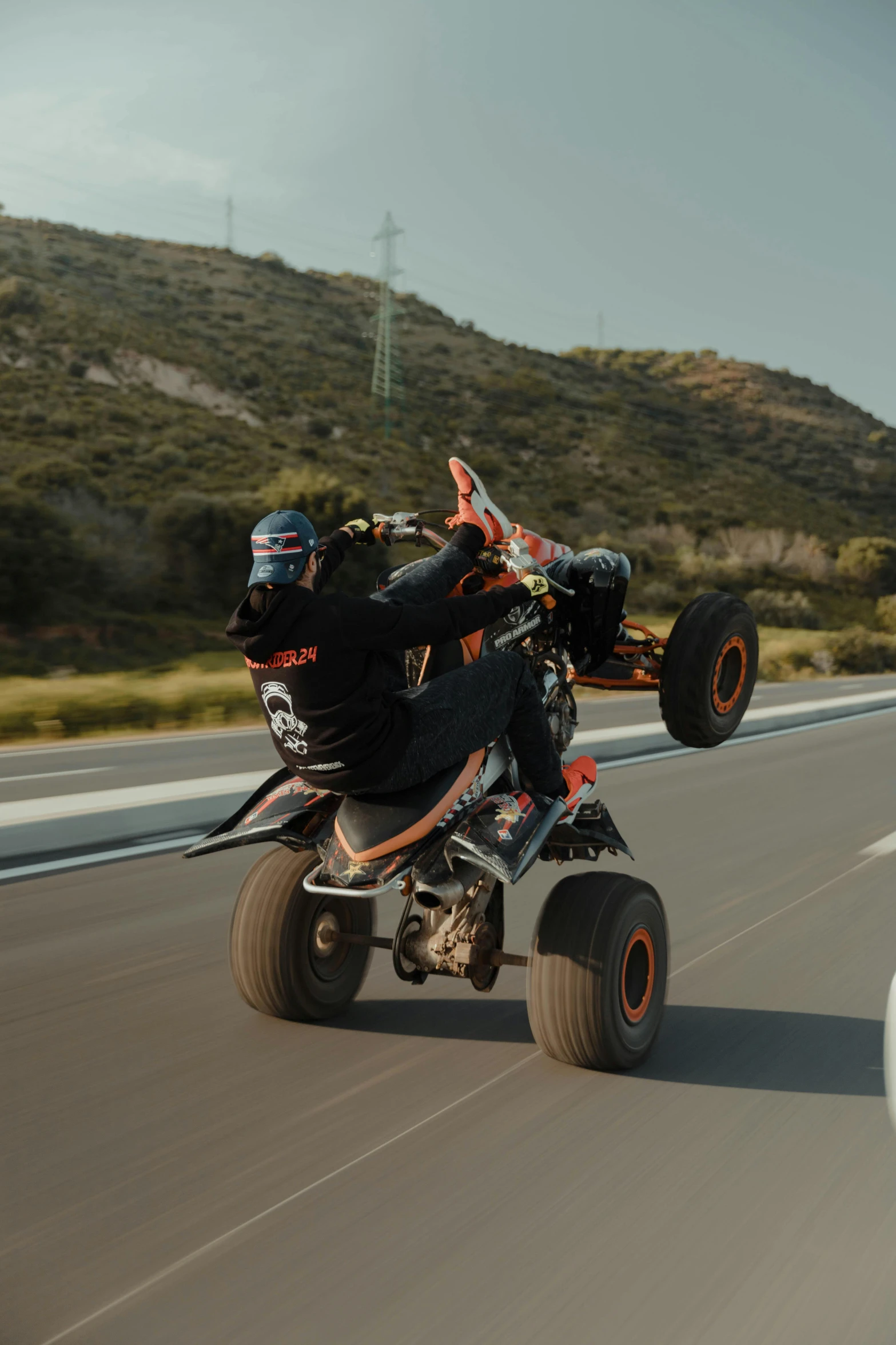 a man on a four wheeled atv in the road