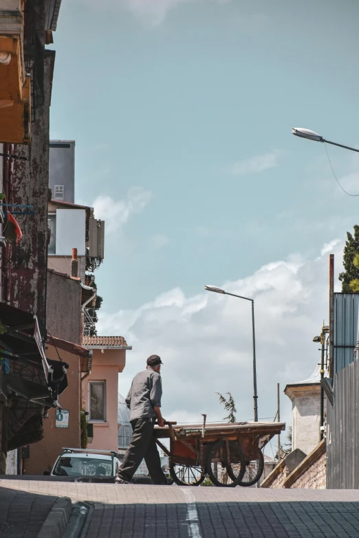 a man that is walking next to a wagon