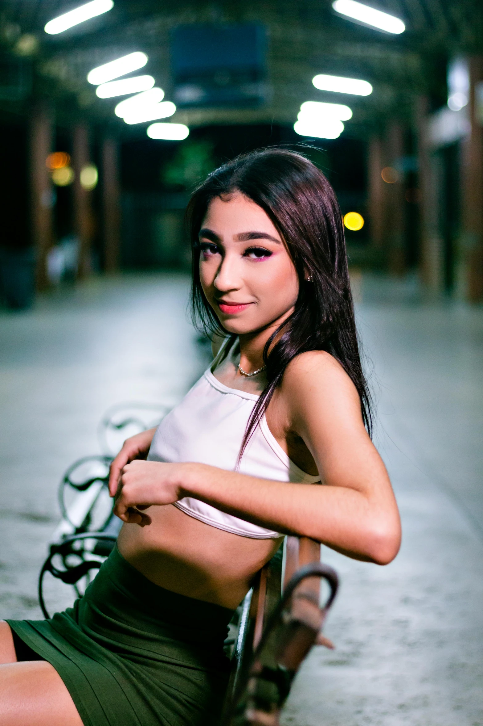 young woman sitting on the ground with her leg in the air