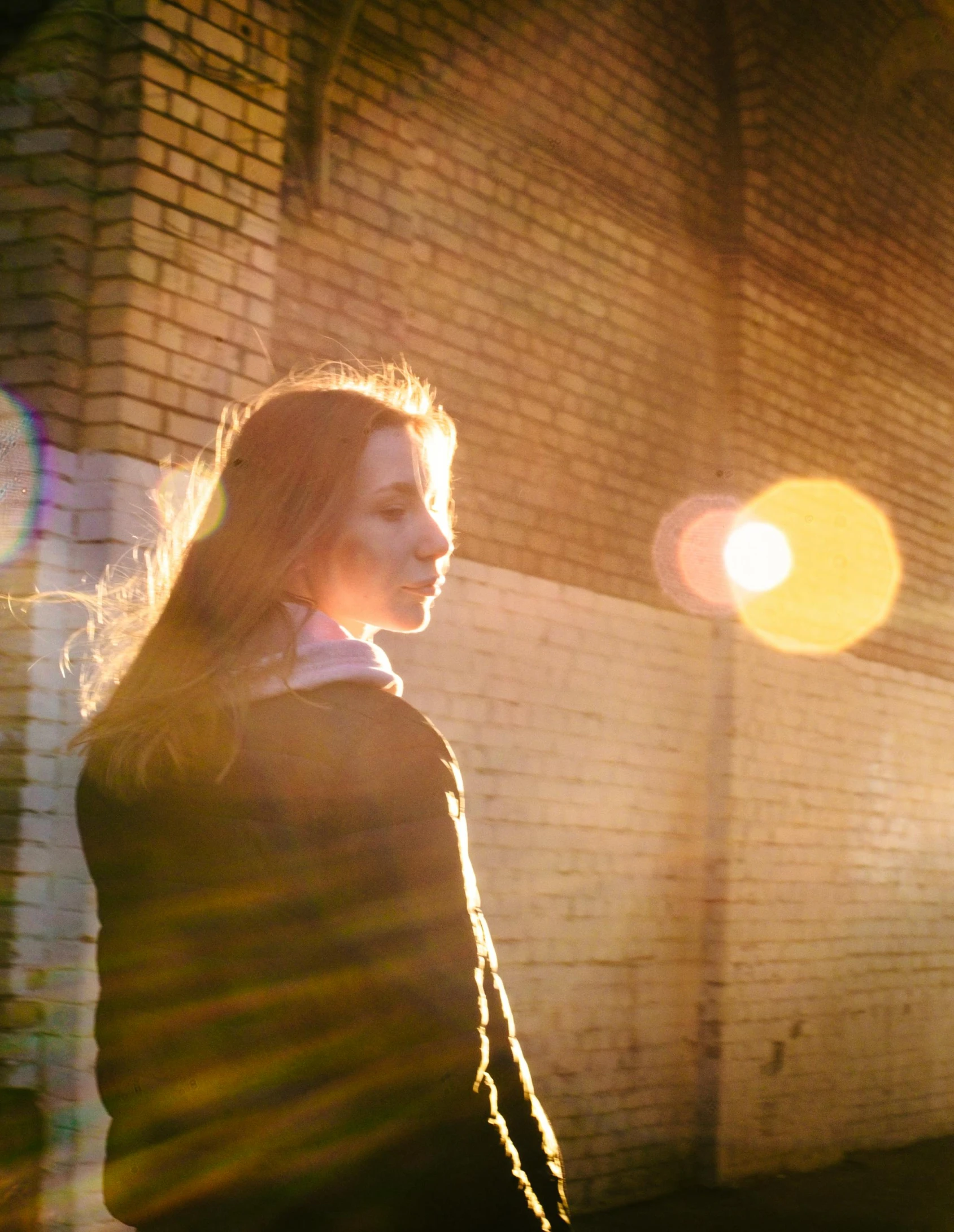 a young woman walking on the sidewalk at night