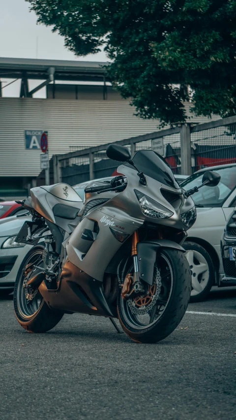 a silver motorcycle is parked in the street