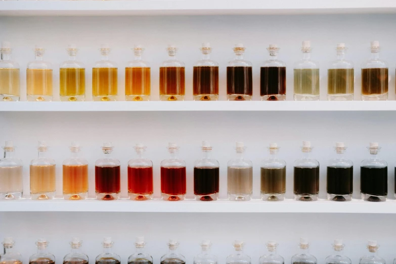 bottles filled with various liquids sitting on shelves