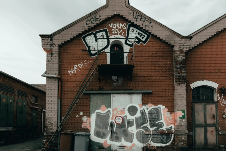 the wall of a building has been painted on with many graffiti