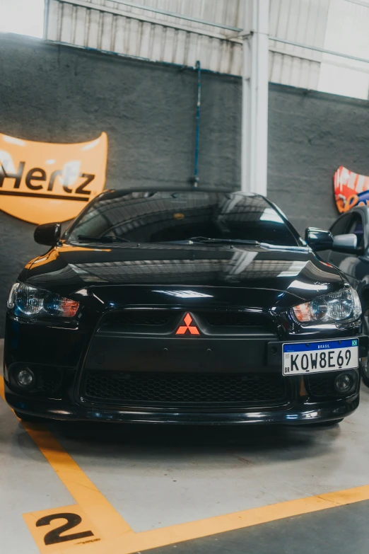 a black sport car parked in a garage