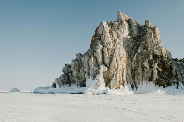 this is a tall rocky mountain in winter