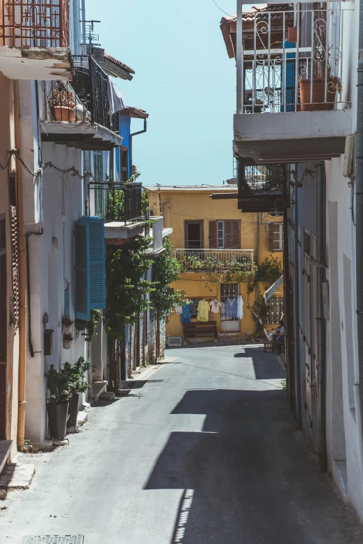 an alleyway of a small town near the ocean