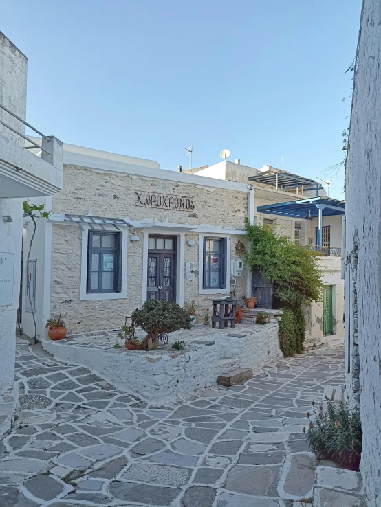 the view from the entrance to a house on a cobblestone street