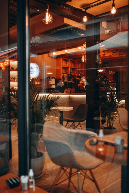 a few grey chairs and a brown table in front of some glass