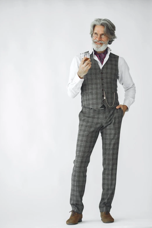 an older man with white hair and beard in plaid dress trousers is taking his picture