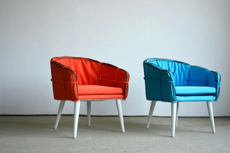 two chairs with different colors sitting next to each other